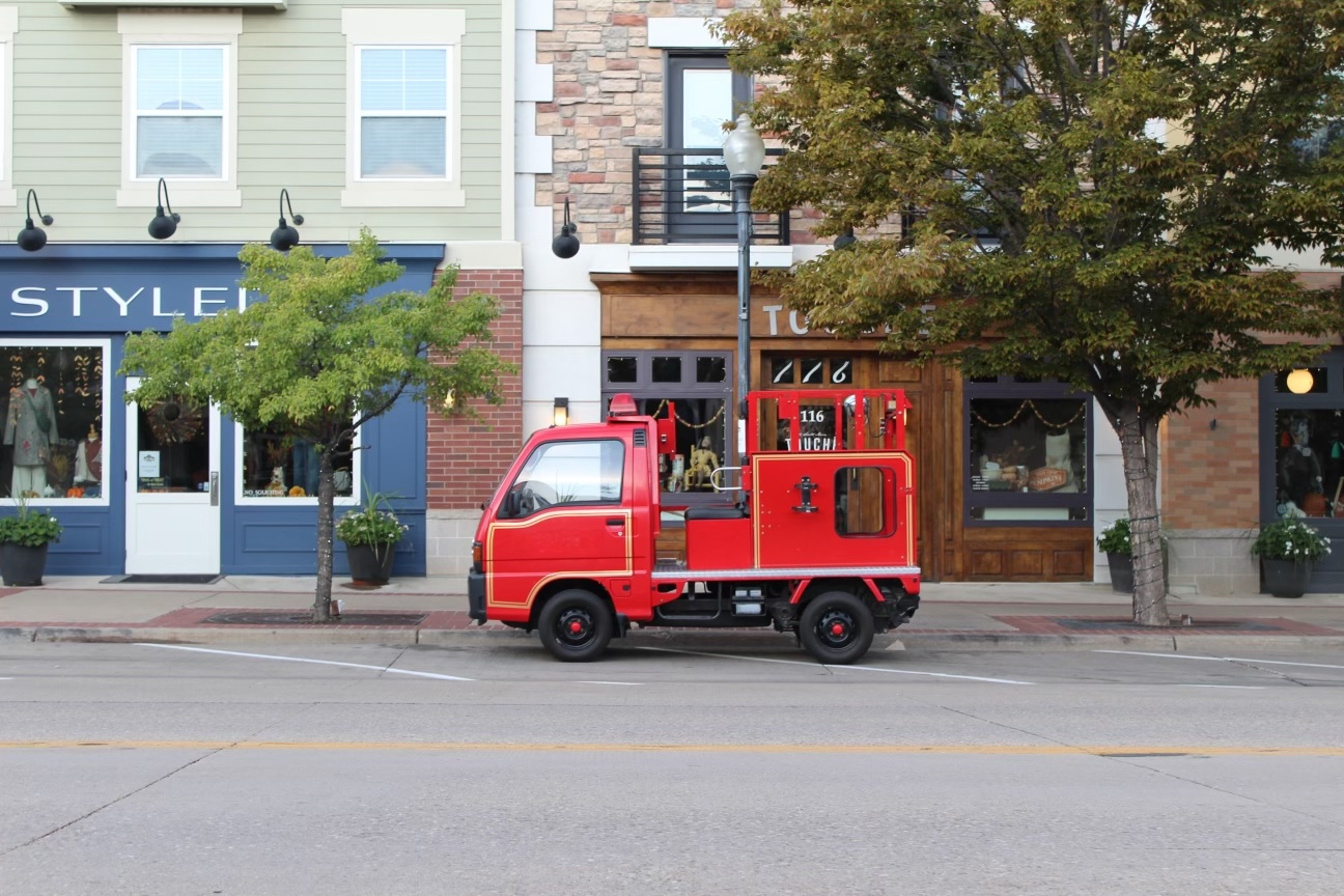Little firetuck parked in front of shops
